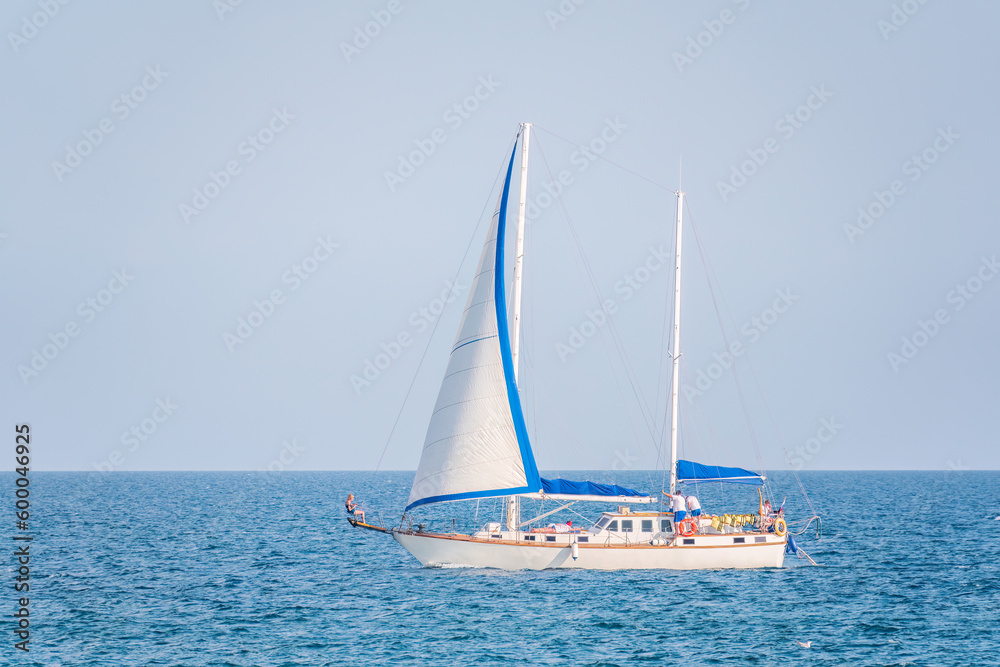 Fototapeta premium Sailing yacht in the blue calm sea.