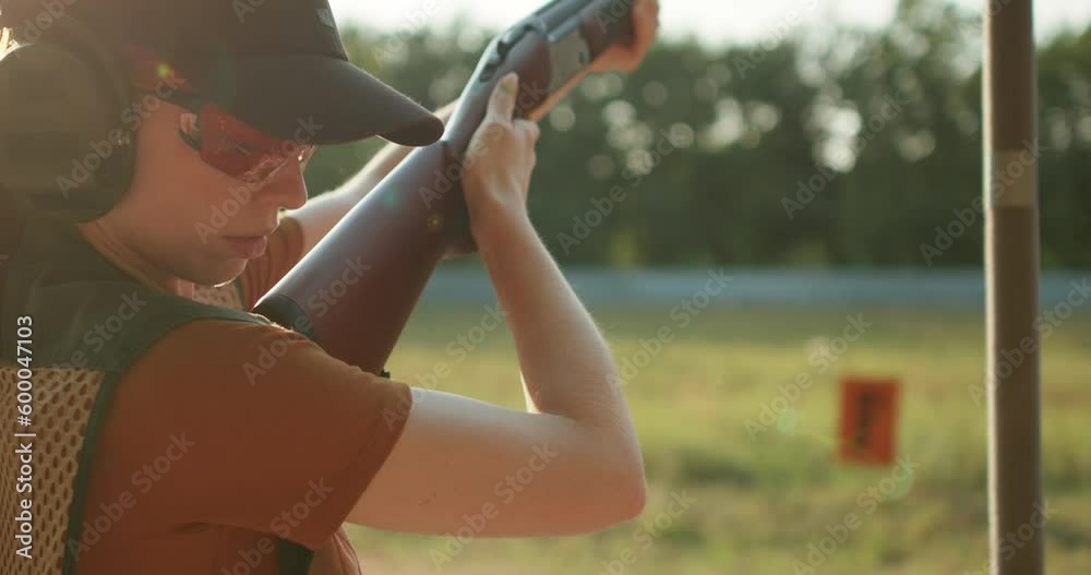 shooter-woman-firing-a-rifle-outdoors-young-redhead-caucasian-woman-is