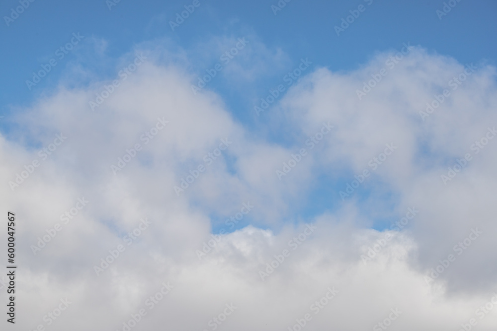 White clouds against the blue sky. Cloudy sky background. White clouds against the blue sky. Cloudy sky background.
