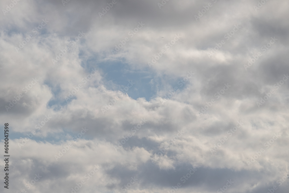 White clouds against the blue sky. Cloudy sky background.