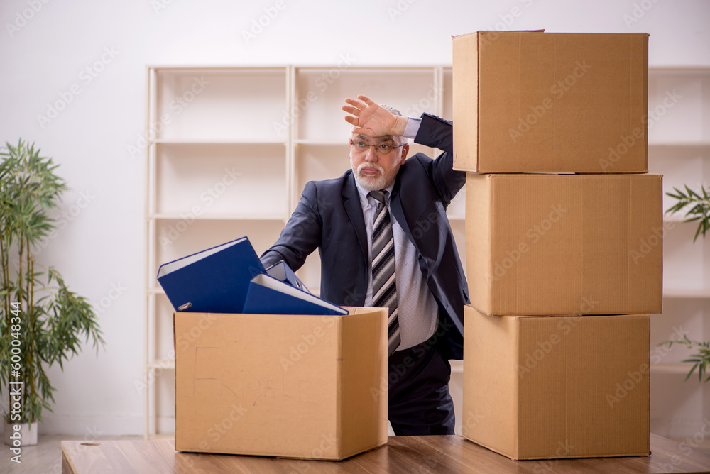 Old male employee in office relocation concept Old male employee in office relocation concept