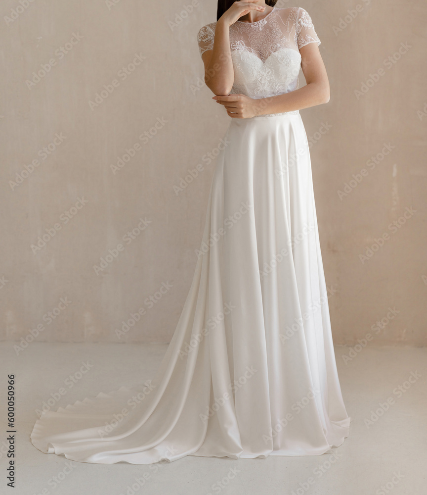 Front view of beautiful bride in the white wedding dress decorated with floral lace. Gorgeous short sleeves wedding dress decorated with lace Front view of beautiful bride in the white wedding dress decorated with floral lace. Gorgeous short sleeves wedding dress decorated with lace