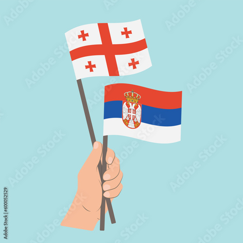 Flags of Georgia and Serbia, Hand Holding flags © Настасья Стось