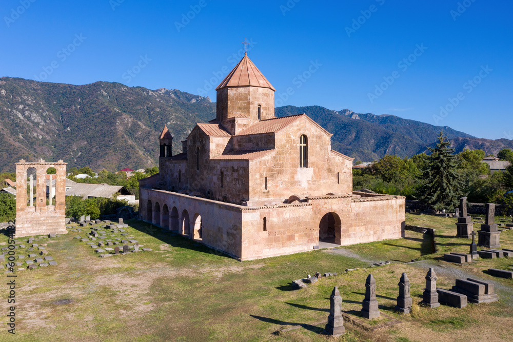 Aerial view of Odzun Church and funerary monument on sunny summer day. Lori Province, Armenia.