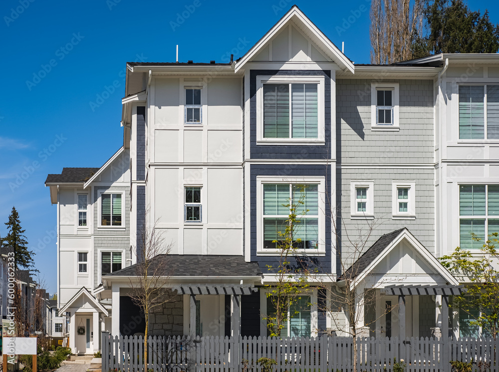 Facade of new residential townhouses. Apartment buildings in Canada. Modern complex of apartment buildings in spring Facade of new residential townhouses. Apartment buildings in Canada. Modern complex of apartment buildings in spring