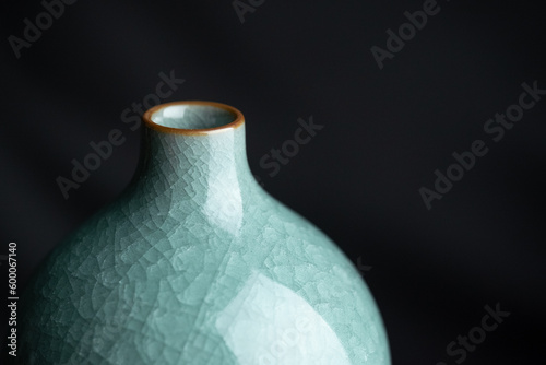 Chinese gourd celadon porcelain with cracks as decoration, traditional porcelain, ornament, close-up, indoor dark background