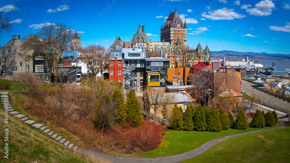 Quebec City's vibrant spring colors, manicured, garden, skyline, architecture, buildings, and view of Fairmont Le Chateau Frontenac in Canada overlooking the St. Lawrence River