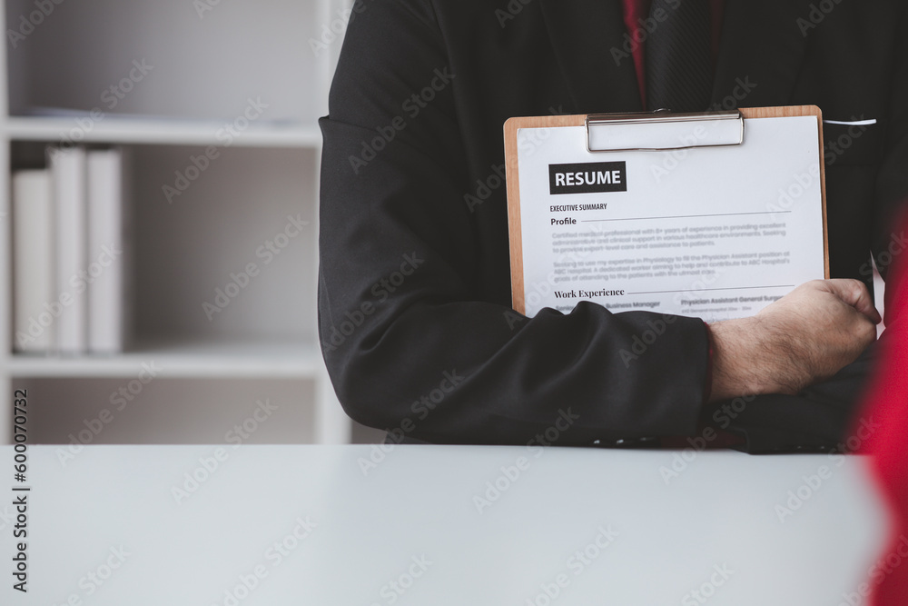Person submitting resume to interview for a job with a company, Person attending a job interview with a manager to be recruited to the company for the position applied for. Job application concept. Person submitting resume to interview for a job with a company, Person attending a job interview with a manager to be recruited to the company for the position applied for. Job application concept.