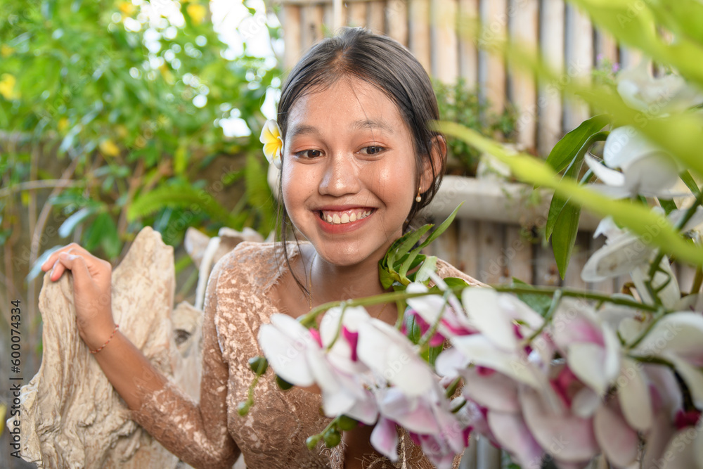 Indonesian beauty female wearing classic dress in balinese gardens