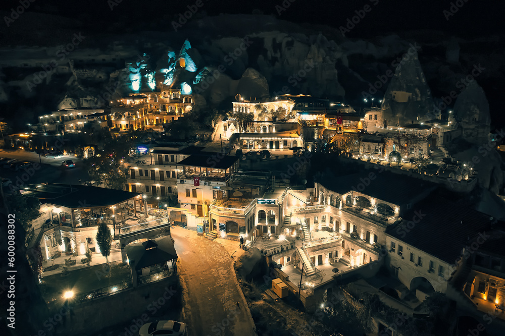 Aerial view of illuminated streets, fairy chimneys and cave hotels at Goreme village, Nevsehir province, Cappadocia, Turkiye