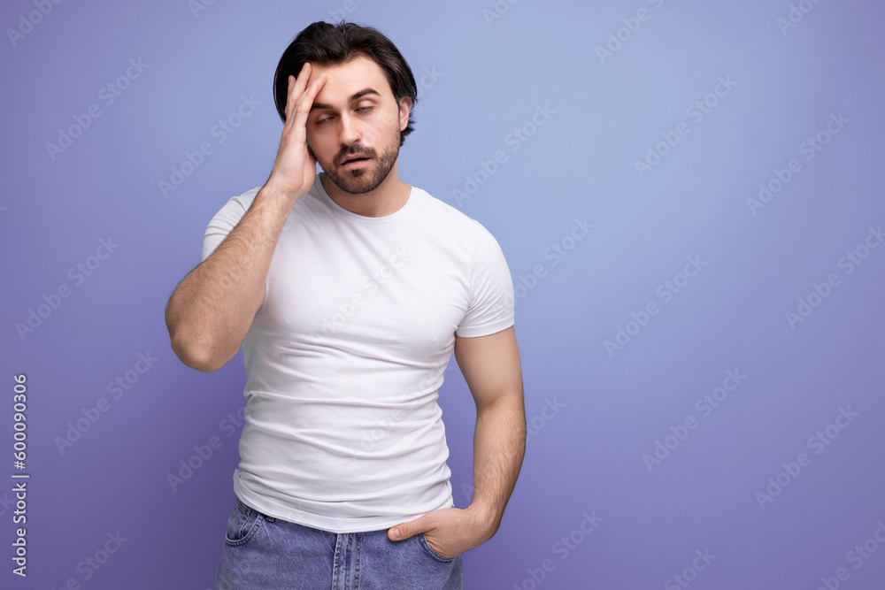 upset brutal brunette man in a white t-shirt and jeans upset brutal brunette man in a white t-shirt and jeans