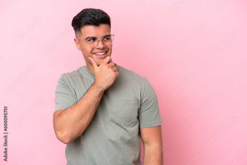 Young caucasian handsome man isolated on pink background looking to the side and smiling Young caucasian handsome man isolated on pink background looking to the side and smiling