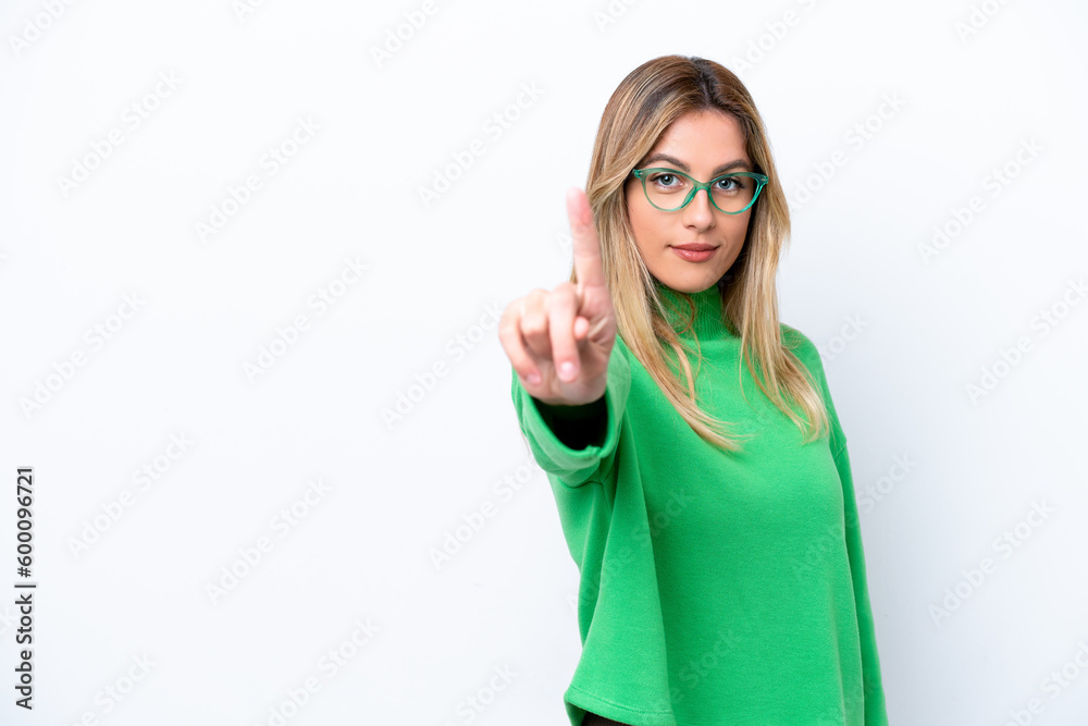Young Uruguayan woman isolated on white background showing and lifting a finger