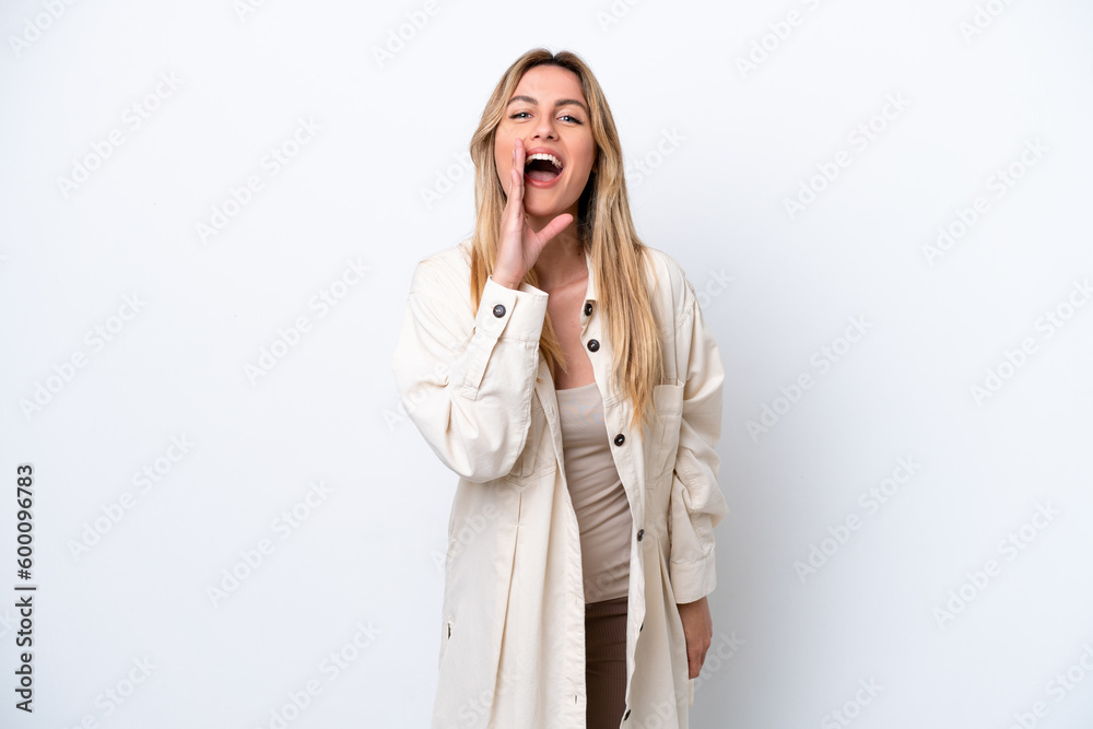 Young Uruguayan woman isolated on white background shouting with mouth wide open