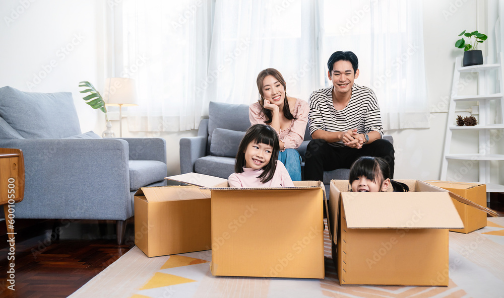 Asian family father mother daughter girl packing cardboard box moving, online marketing e-commerce unpacking stuff belongings home delivery. Lifestyle happy asian family together relocation concept. Asian family father mother daughter girl packing cardboard box moving, online marketing e-commerce unpacking stuff belongings home delivery. Lifestyle happy asian family together relocation concept.