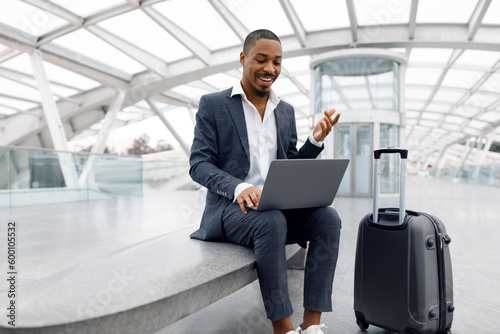 Teleconference. Black Businessman Making Video Call On Laptop At Airport