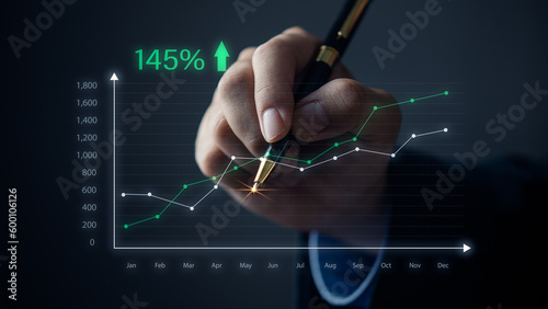 hand holding pen graph virtual screen. Concept marketing investment finance business.