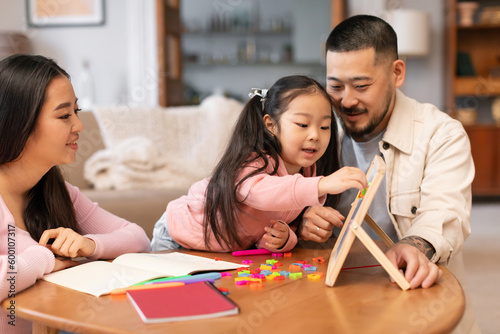 Japanese Parents Teaching Preschool Daughter Playing Learning Games At Home