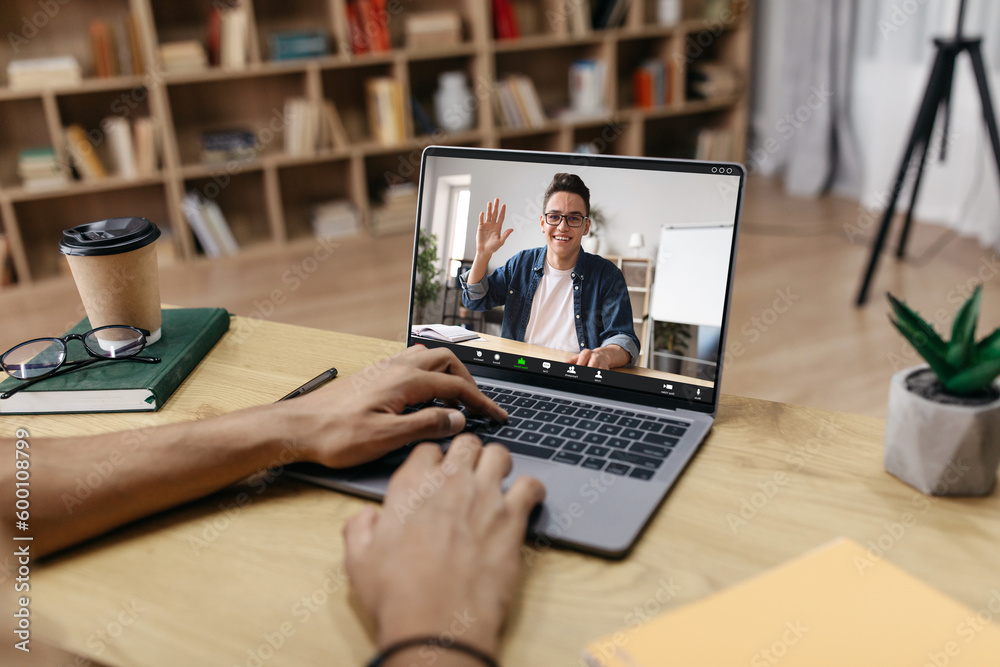 Unrecognizable man typing on laptop, having online lesson Unrecognizable man typing on laptop, having online lesson