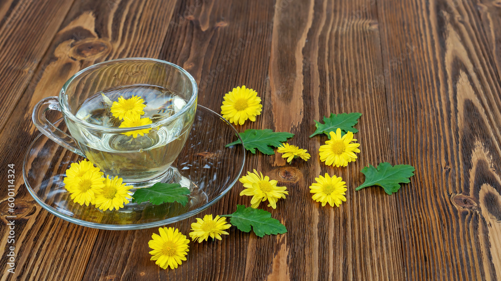 Yellow chrysanthemum flower tea on a wooden table. Yellow chrysanthemum flower tea on a wooden table.