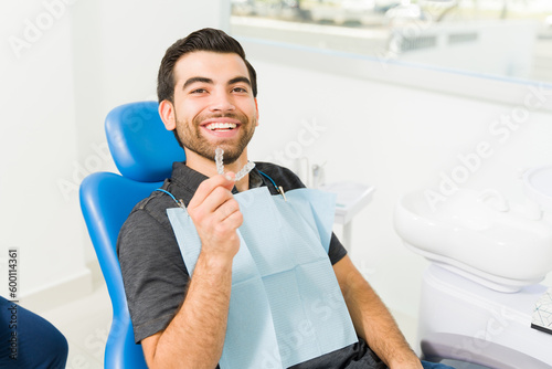 Close up of a happy man using invisible orthodontics photo