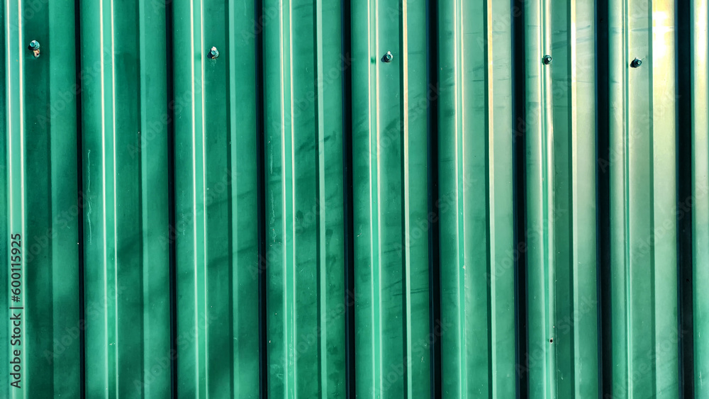 Green Metal fence with vertical picket fence and lines. Abstract background, frame, texture with place for text and copy space Green Metal fence with vertical picket fence and lines. Abstract background, frame, texture with place for text and copy space