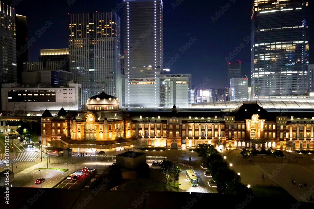 夜にライトアップされた東京駅の駅舎と丸の内の高層ビルと幻想的な夜景・デートスポット（東京都千代田区）
