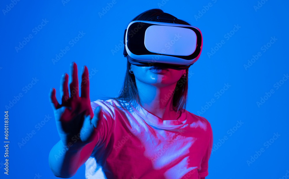 Brunette woman with VR headset touching something what she see in virtual world. Futuristic technology. Brunette woman with VR headset touching something what she see in virtual world. Futuristic technology.