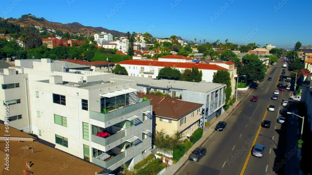 Aerial Backward Shot Of Apartments By Street In City On Sunny Day - Los Angeles, California Aerial Backward Shot Of Apartments By Street In City On Sunny Day - Los Angeles, California