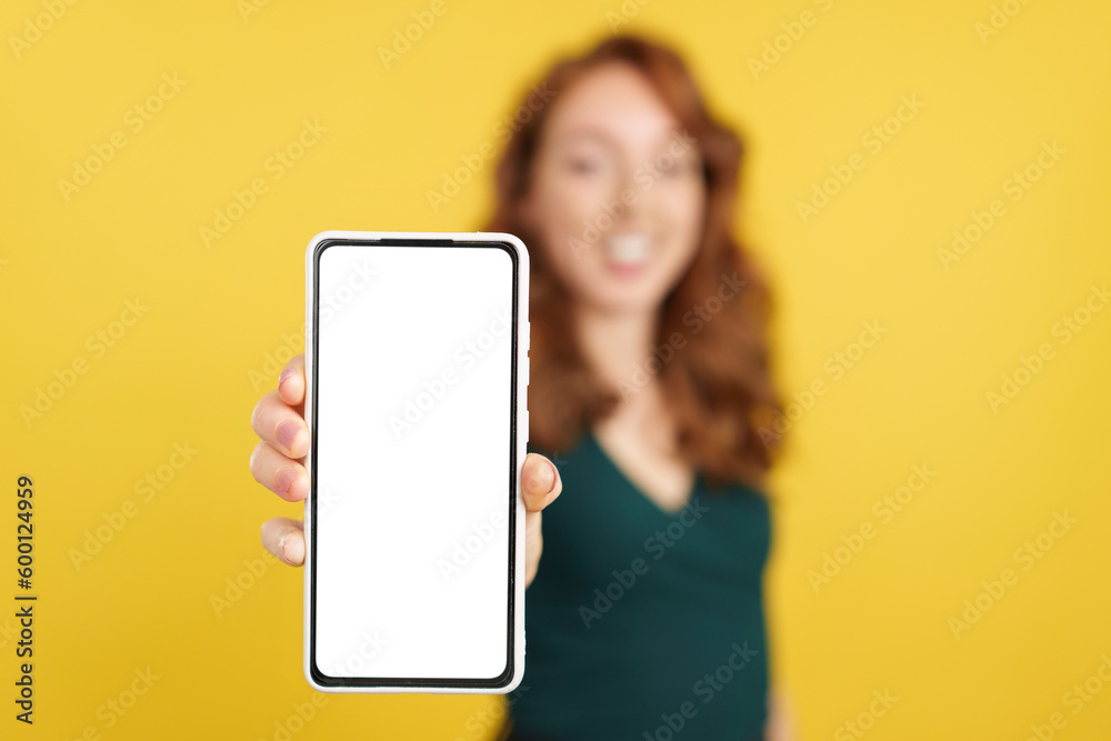 Blank screen of the mobile held by a redheaded woman