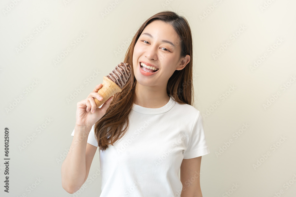 Cheerful enjoy, portrait of happy asian woman have fun with brunette hair, holding ice cream waffle cone chocolate cream tasty, enjoy girl hold delicious frozen dessert, sweet in summer hot weather. Cheerful enjoy, portrait of happy asian woman have fun with brunette hair, holding ice cream waffle cone chocolate cream tasty, enjoy girl hold delicious frozen dessert, sweet in summer hot weather.