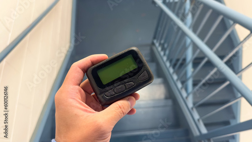 Hospital work pager and technology symbolize efficient communication and coordination between medical professionals, ensuring timely and effective patient care photo