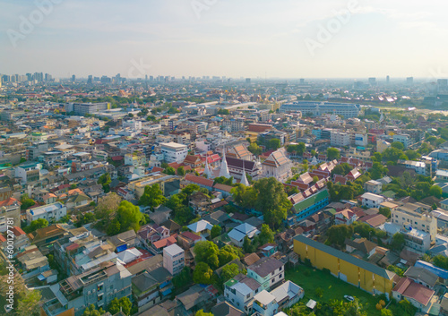 Aerial top view of Wat Ratchanatdaram Pagoda, a buddhist temple or Wat Saket in Bangkok Downtown, urban city with sunset sky, Thailand. Thai architecture landscape background.