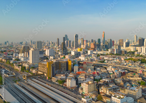 Aerial view of Hua Lamphong or Bangkok Railway Terminal Station with skyscraper buildings in urban city, Bangkok downtown skyline, Thailand. Cars on traffic street road on highways.