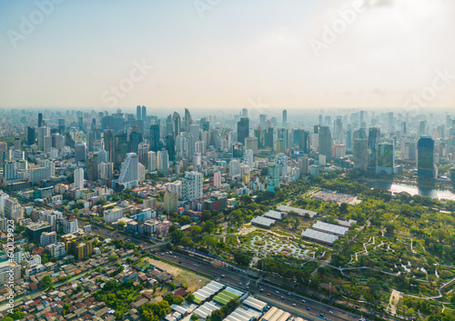 Aerial view of green trees in Lumpini Park, Sathorn district, Bangkok Downtown Skyline. Thailand. Financial district and business center in smart urban city in Asia. Skyscraper buildings photo