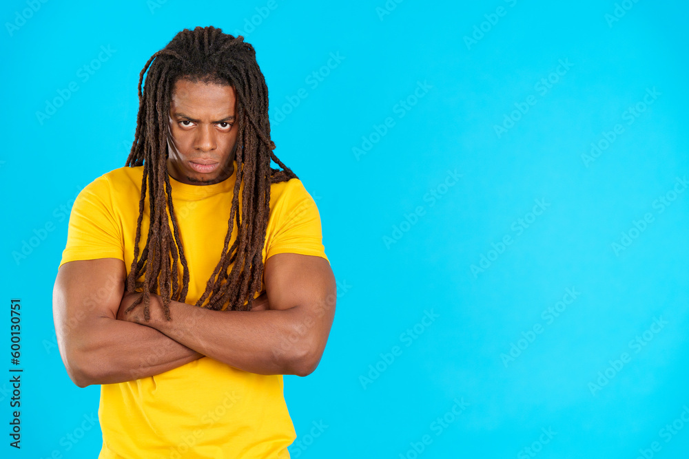 Latin man with dreadlocks crossing the arms with angry expression Latin man with dreadlocks crossing the arms with angry expression