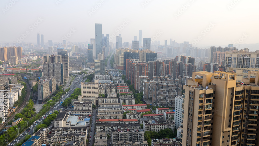 modern complex and traffic along on busy road from daytime to evening photo at high-rise building near junction of Liuyang and Xiangjiang rivers, Changsha, China