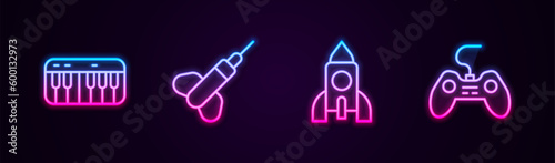 Set line Music synthesizer, Dart arrow, Rocket ship toy and Gamepad. Glowing neon icon. Vector
