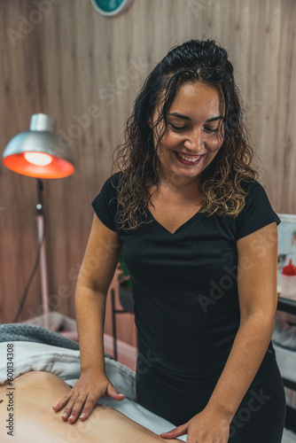 Relaxing woman back massage with physiotherapist in clinical center