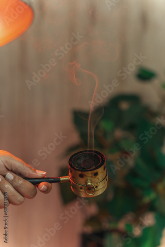 Moxibustion treatment: Traditional Chinese medicine tools for heating acupuncture point therapy. chinese herbal medicine Copper moxibustion burner box with herbal moxa sticks in holistic clinic.