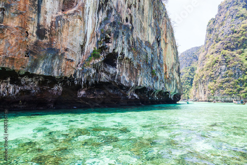 A picturesque beautiful place on the island of Phi Phi Leh - Pi Leh Lagoon is popular for excursions with tourists on traditional Thai fishing boats. Island travel in Thailand.