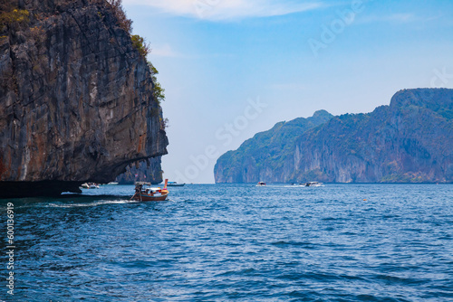 A picturesque beautiful place on the island of Phi Phi Leh - Pi Leh Lagoon is popular for excursions with tourists on traditional Thai fishing boats. Island travel in Thailand.