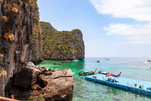 Pier or jetty on phi phi leh island in krabi in thailand near maya bay with boats and tourists on a hot sunny day. Travel and vacation.