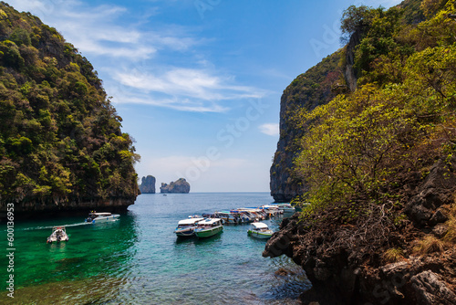 Pier or jetty on phi phi leh island in krabi in thailand near maya bay with boats and tourists on a hot sunny day. Travel and vacation.