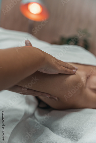 Relaxing woman shoulder massage with physiotherapist in clinic center