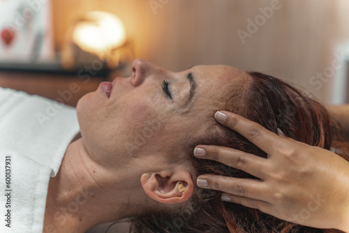 Girl doing relaxation head massage in beauty salon. Unforgettable sensations of lightness and liveliness. deep relaxation technique Her fingers are massaging a beautiful girl's head. nice feelings