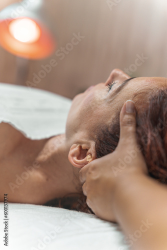 Girl doing relaxation head massage in beauty salon. Unforgettable sensations of lightness and liveliness. deep relaxation technique Her fingers are massaging a beautiful girl's head. nice feelings