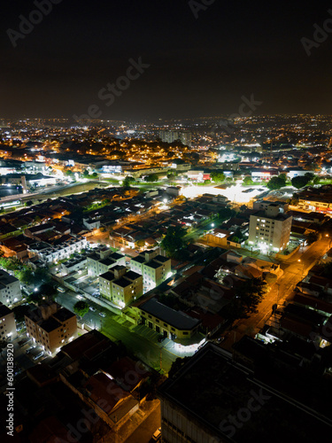Night aerial photography of the city of Campinas  S  o Paulo. Dramatic shadows  dark skies and just lights from cars and surrounding buildings. Shopping Unimart and Anhanguera Highway.