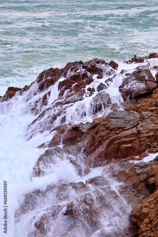closeup of ocean waves crashing on rocks closeup of ocean waves crashing on rocks