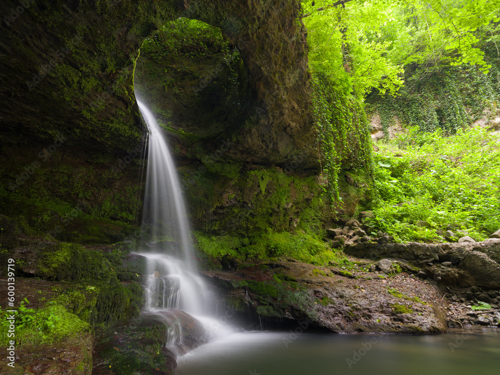 Fascinating forest waterfall. River flowing through a hole in a rock. Murgul Deliklikaya Waterfall. Black sea region. Baskoy village of Artvin. Turkey